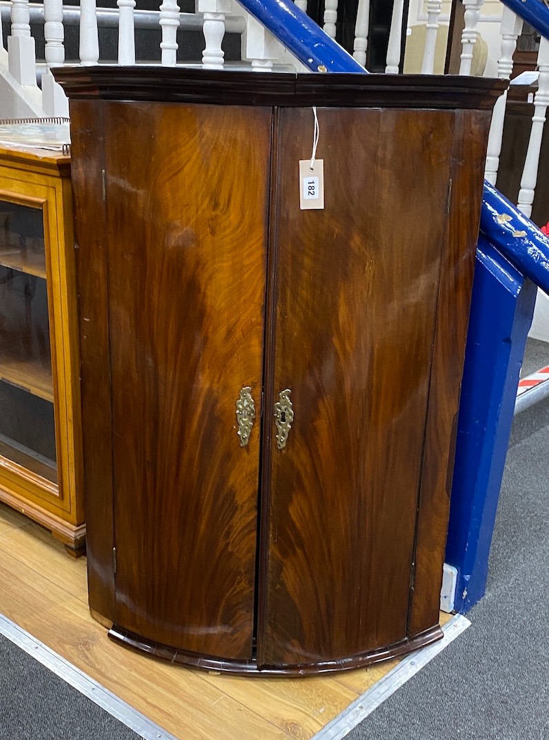 A George III mahogany bow front hanging corner cabinet, width 72cm, depth 50cm, height 102cm
